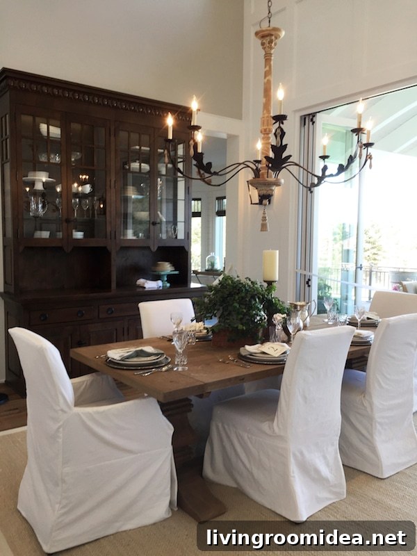 Farmhouse Dining Room with Slipcovered Chairs and Wood Farm Table - Street of Dreams - The Inspired Room