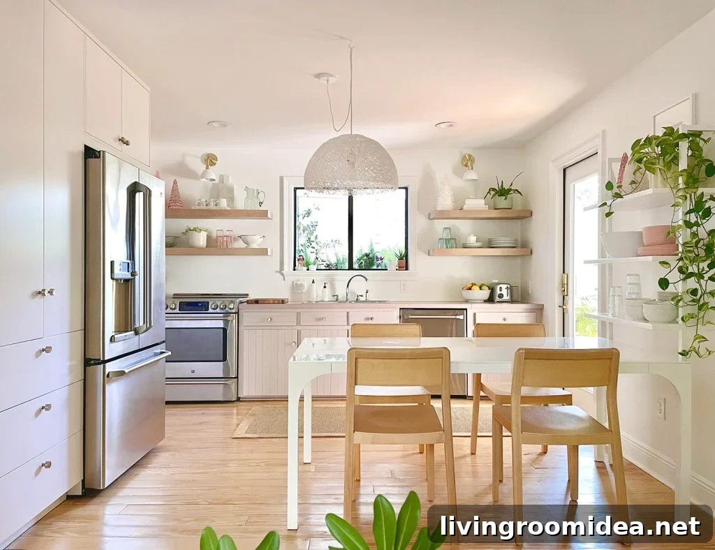 Full view of white kitchen with mauve cabinets and wood chairs