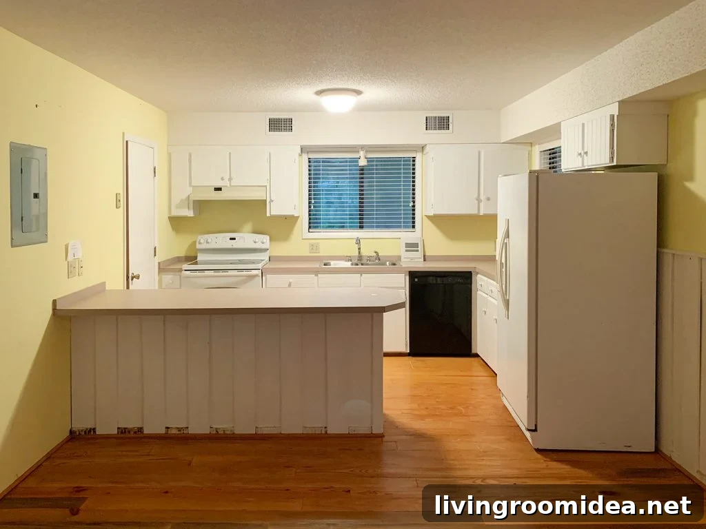Before photo of kitchen with yellow walls and soffit