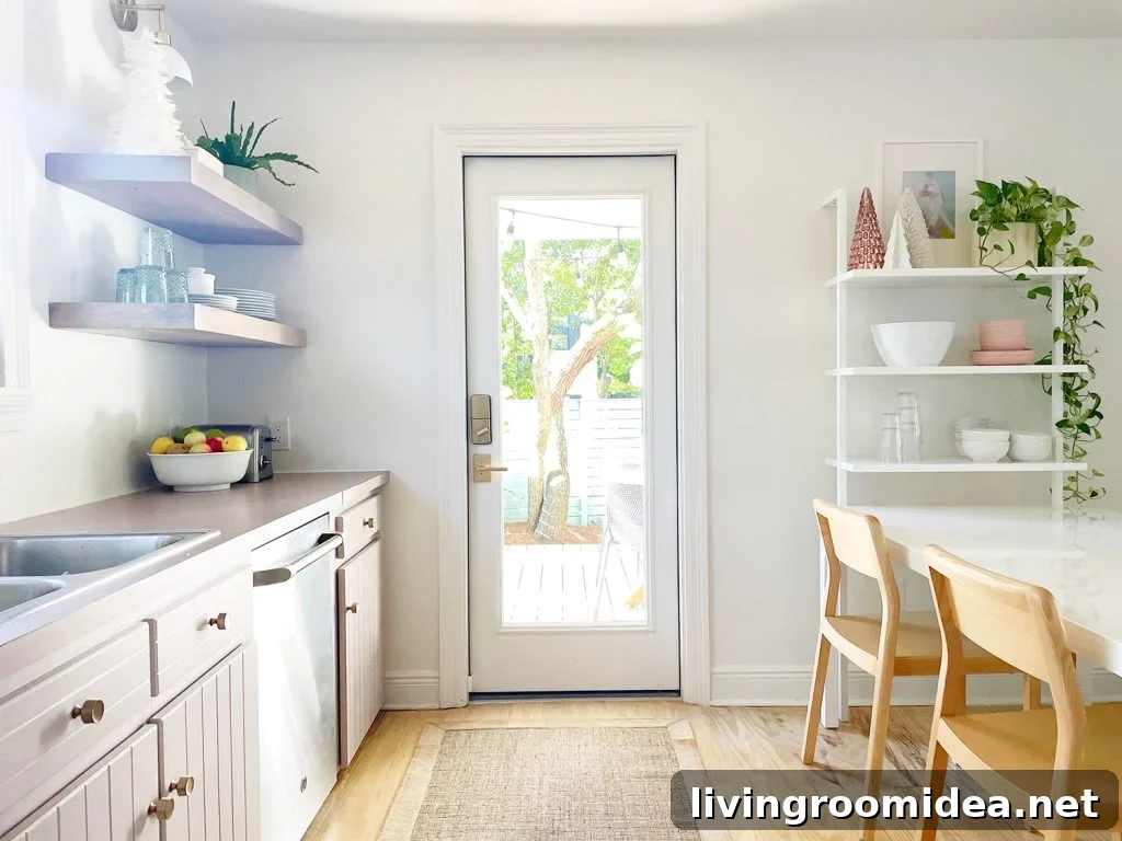 white kitchen with door out to patio